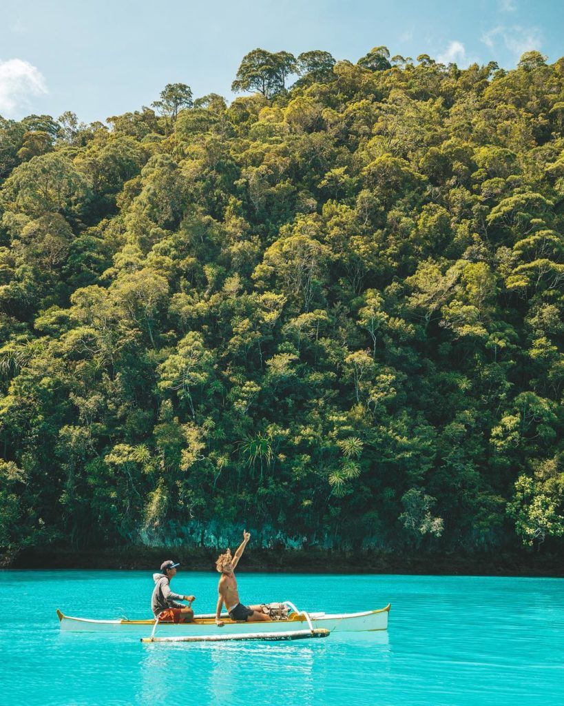a man and a woman in a canoe on a lake.