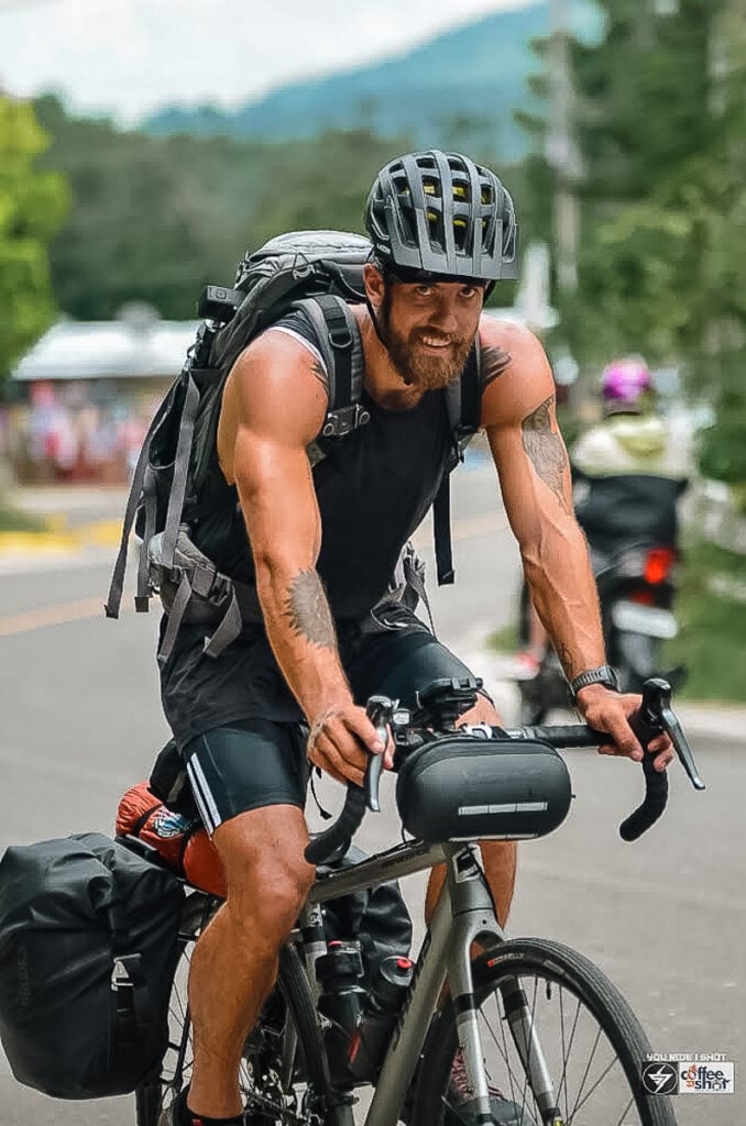 a man riding a bike down a street