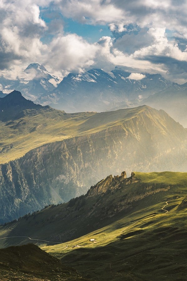 a view of a mountain range with a few sheep grazing.