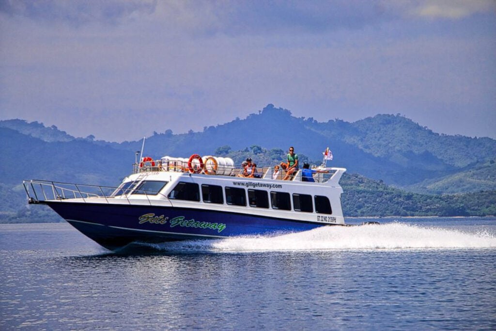 a blue and white boat with people on top of it