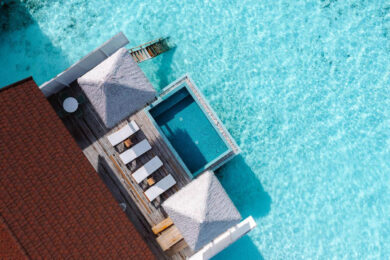 an aerial view of a house on the water