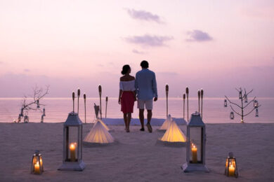 a man and a woman standing on a beach