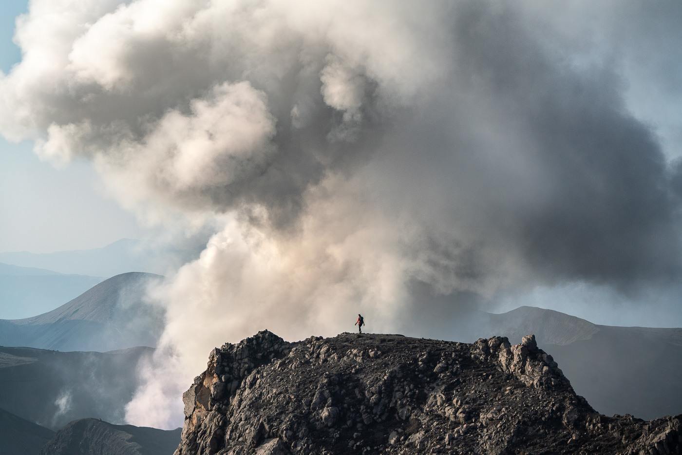 a person standing on top of a mountain.