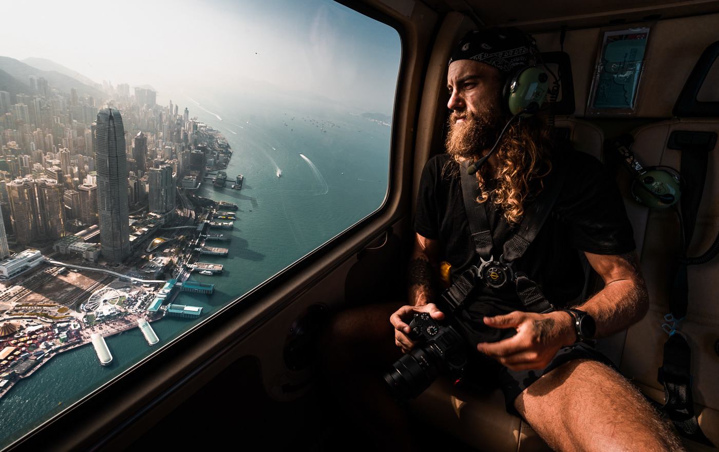 a man sitting in a plane looking out the window.