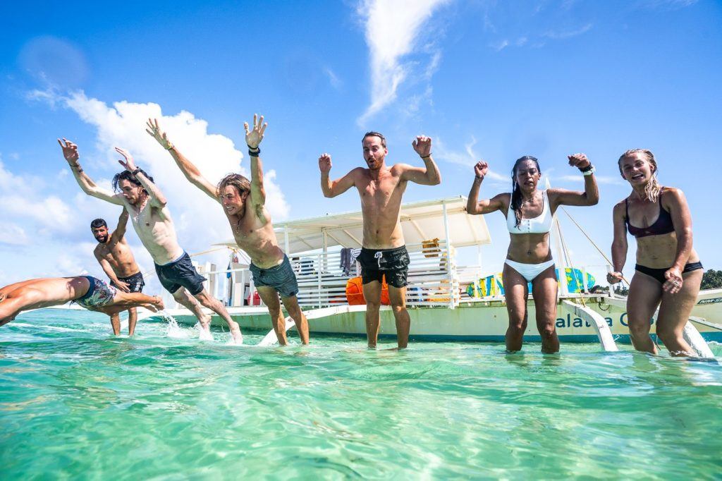 a group of people jumping in the water.
