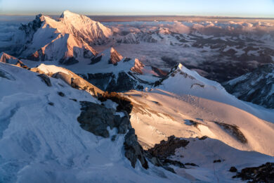 a view of a snowy mountain range from a plane