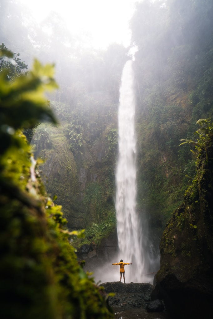 a person standing in front of a waterfall