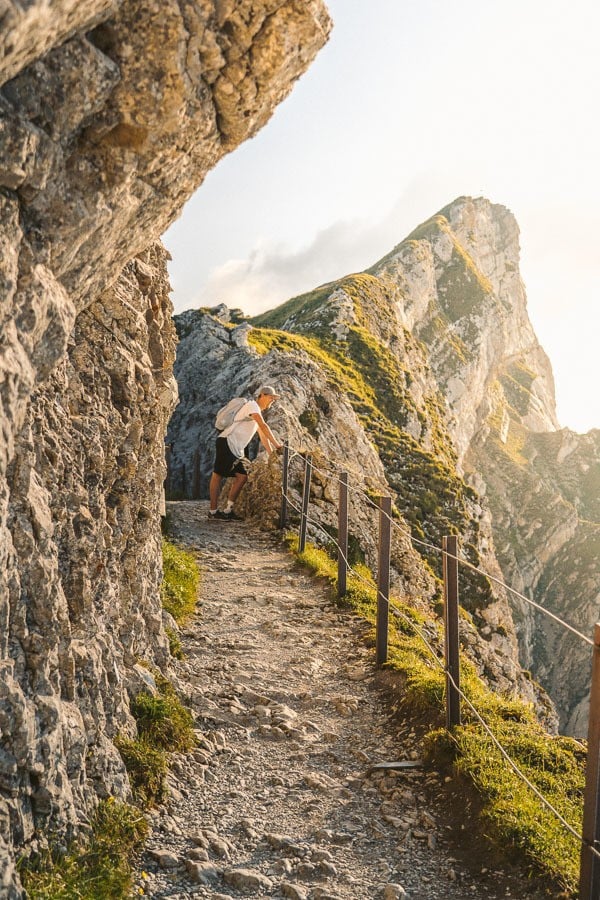 a man is walking up a steep hill.