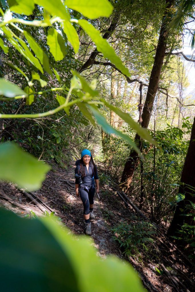 a man with a backpack is hiking through the woods.