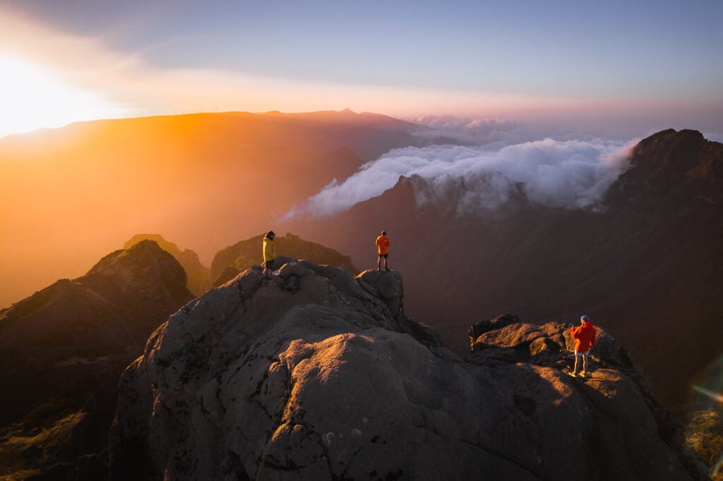 a group of people standing on top of a mountain