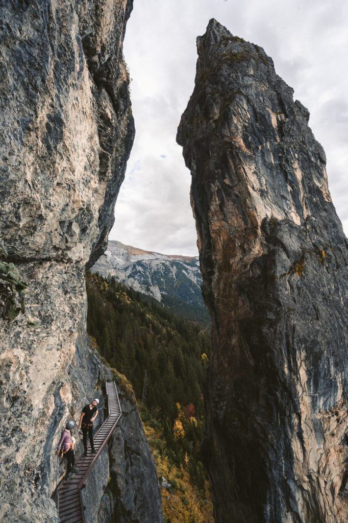 a couple of people standing on top of a mountain.