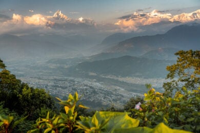 a view of a valley with mountains in the background