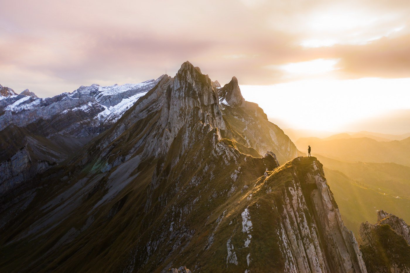 a person standing on top of a mountain.
