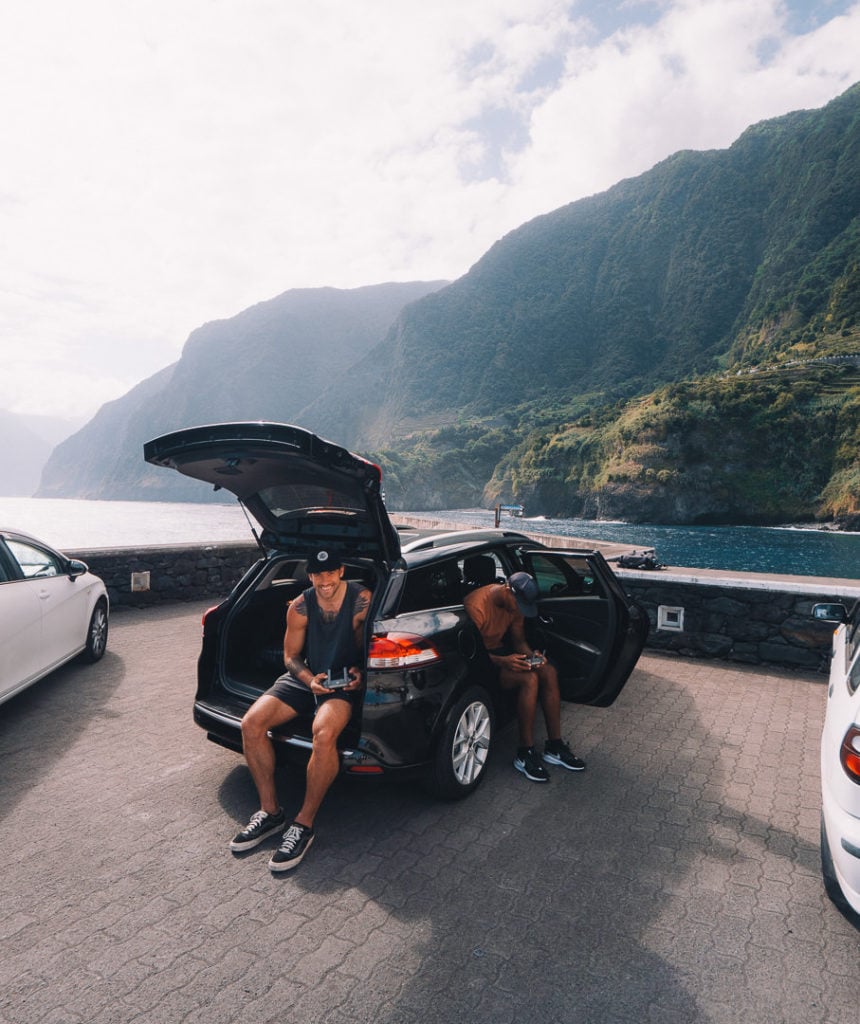 a couple of people sitting in the trunk of a car.