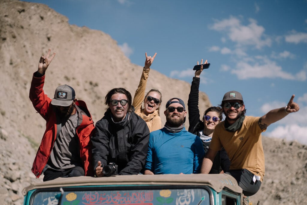 a group of people riding on the back of a truck