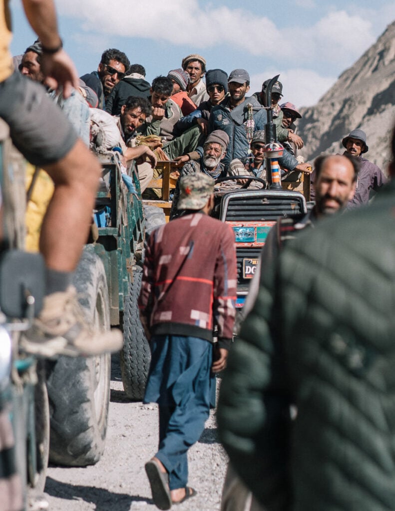 a group of people riding on the back of a truck
