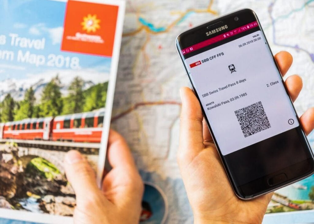 a person holding a smartphone with a map and a qr code.