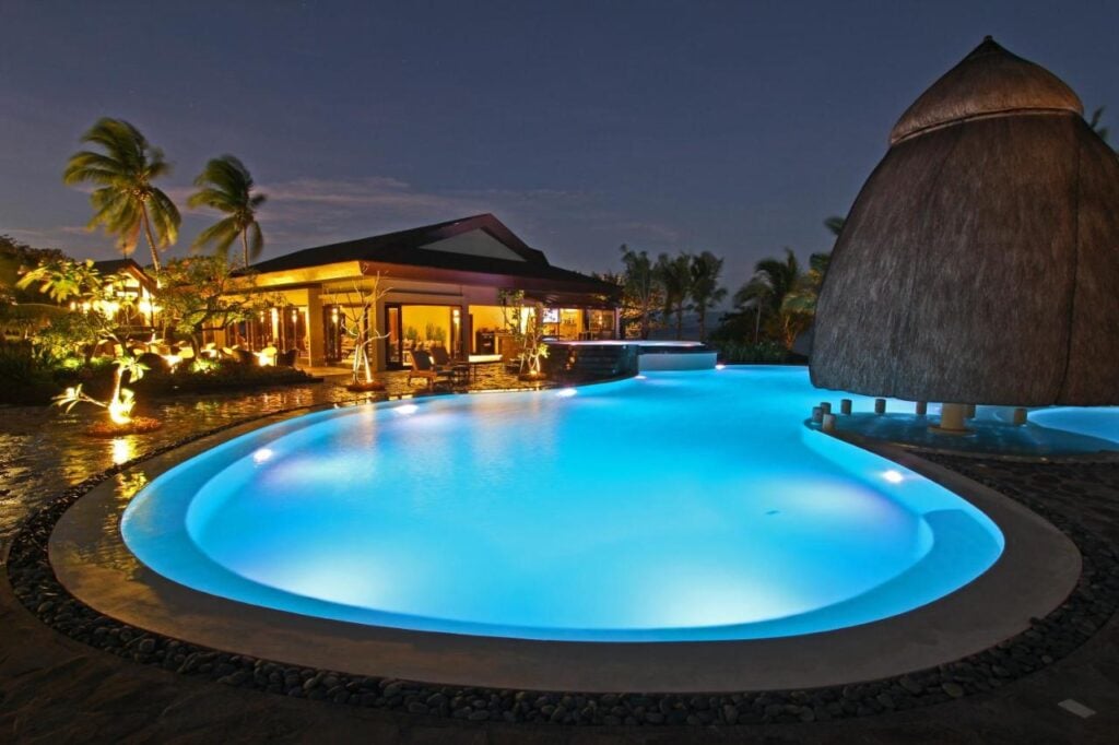 a large swimming pool lit up at night