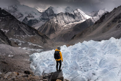 a man standing on top of a snow covered mountain