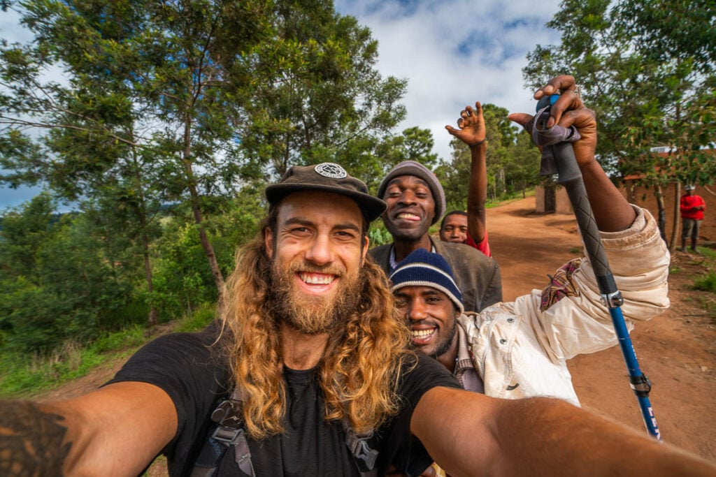 a group of people taking a selfie on a dirt road