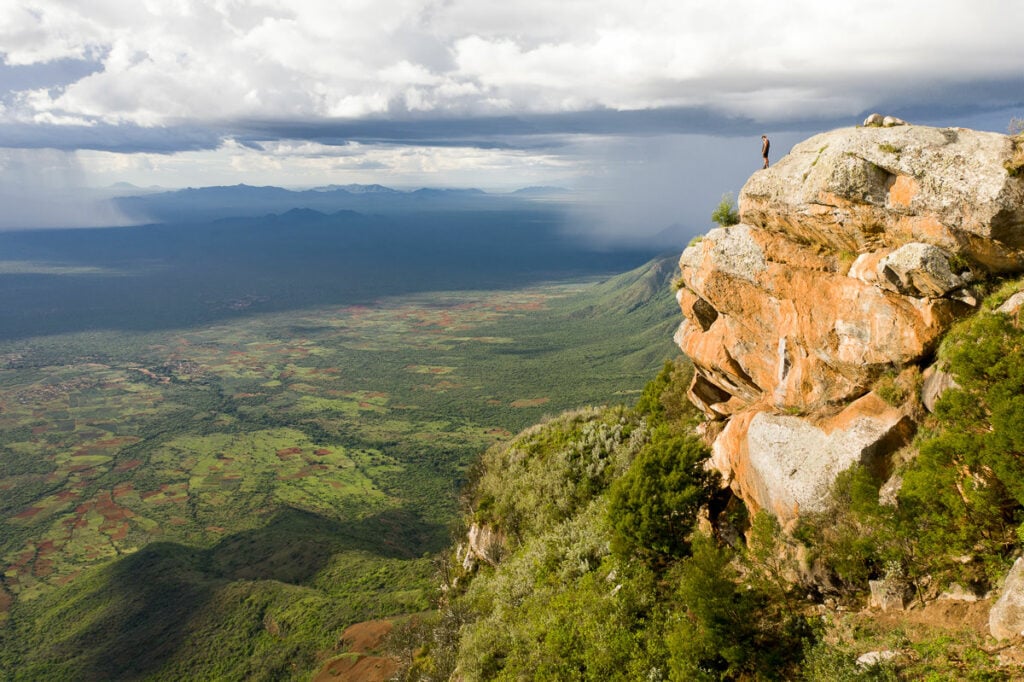 a person standing on top of a cliff