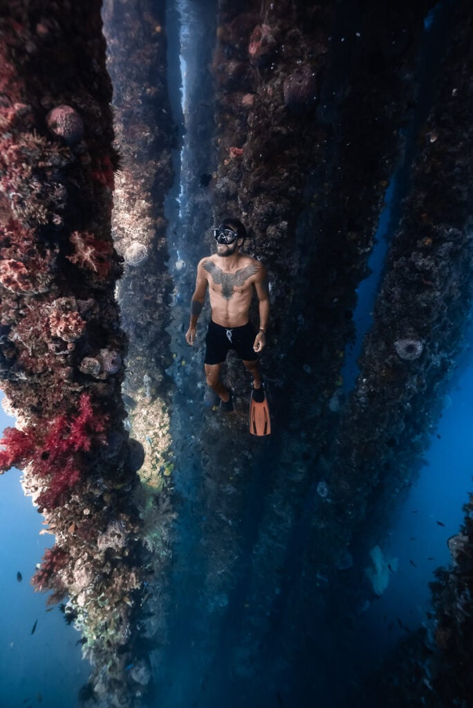 a man with a diving mask standing in the water