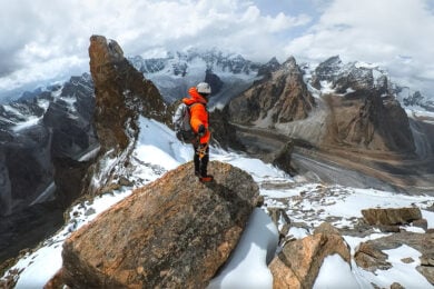 a man standing on top of a snow covered mountain