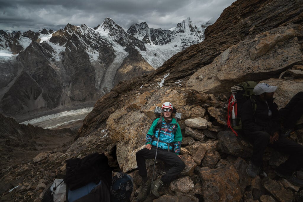 a man sitting on top of a rocky mountain