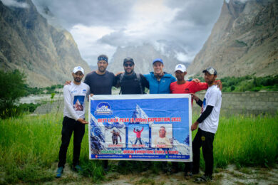 a group of men standing next to each other holding a sign