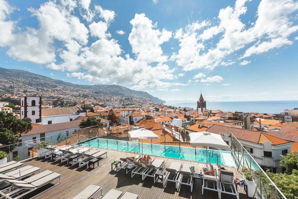 a view of a swimming pool and a city.