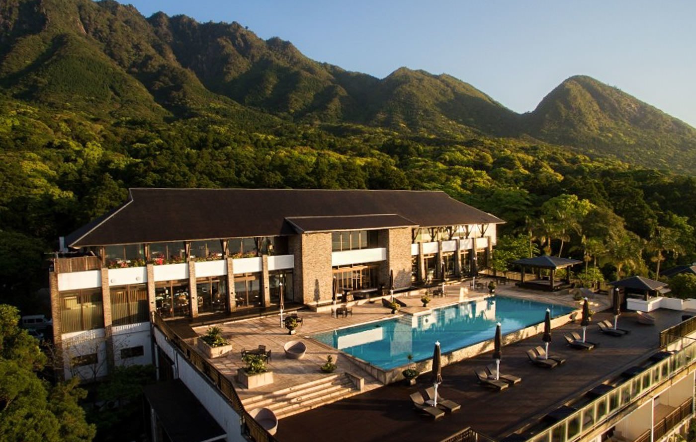 an aerial view of a resort with a swimming pool.