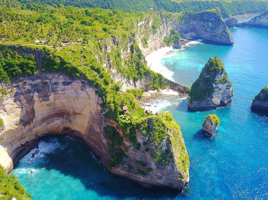 a large body of water next to a cliff.
