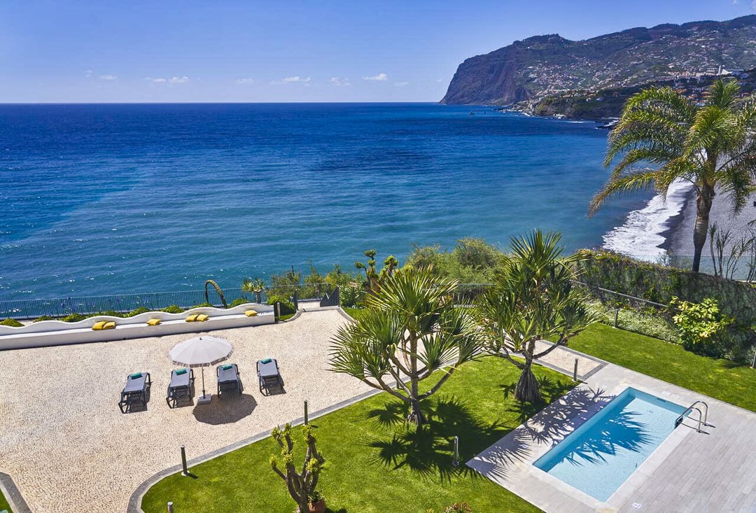 an aerial view of a pool and a beach.