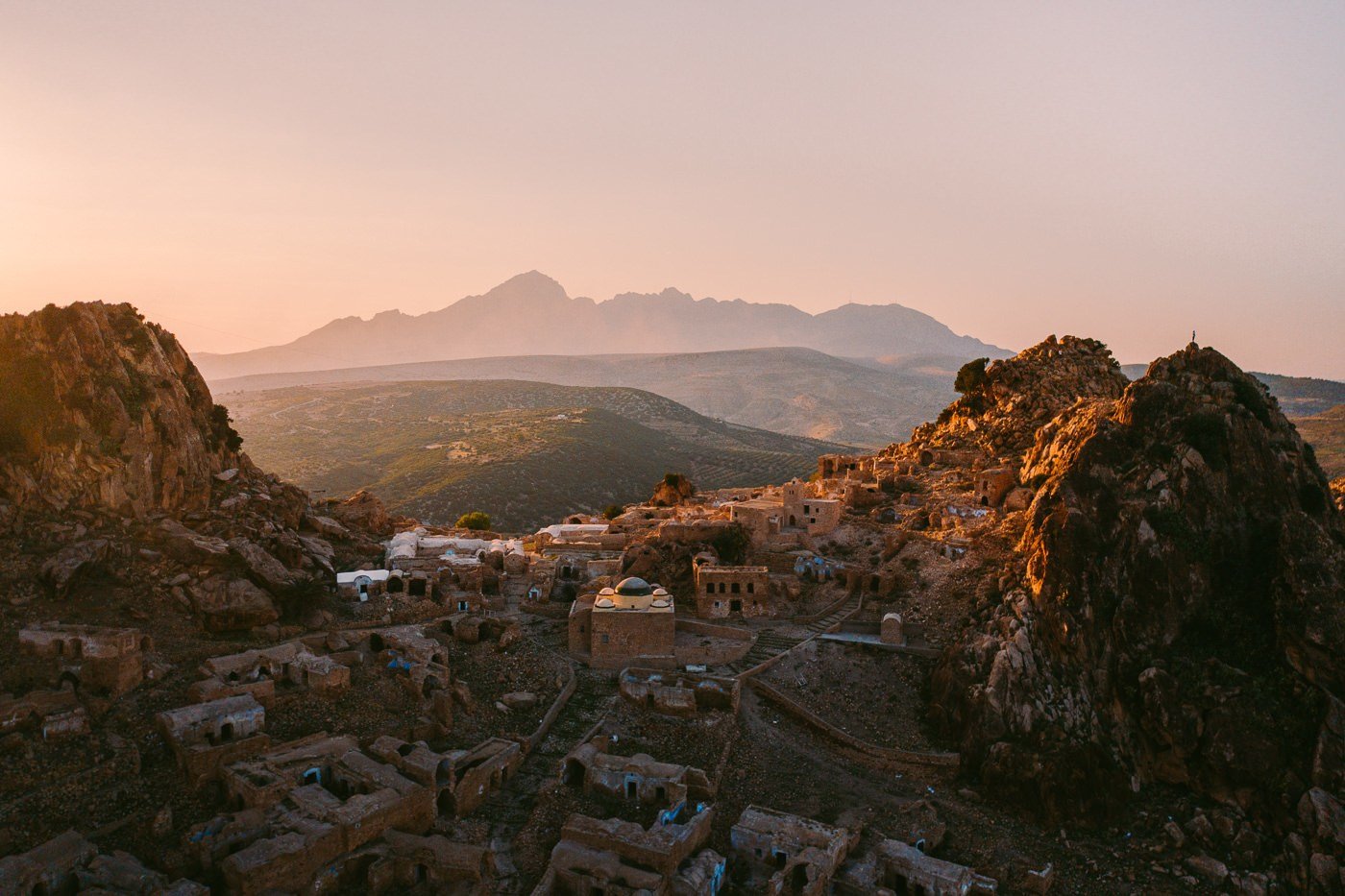 a view of a small town in the mountains.